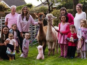 Heather Clarke from Newport is holding a breast cancer fundraiser at her home. She is pictured with husband Mike, the alpacas Carlos and Teddy, and family and friends