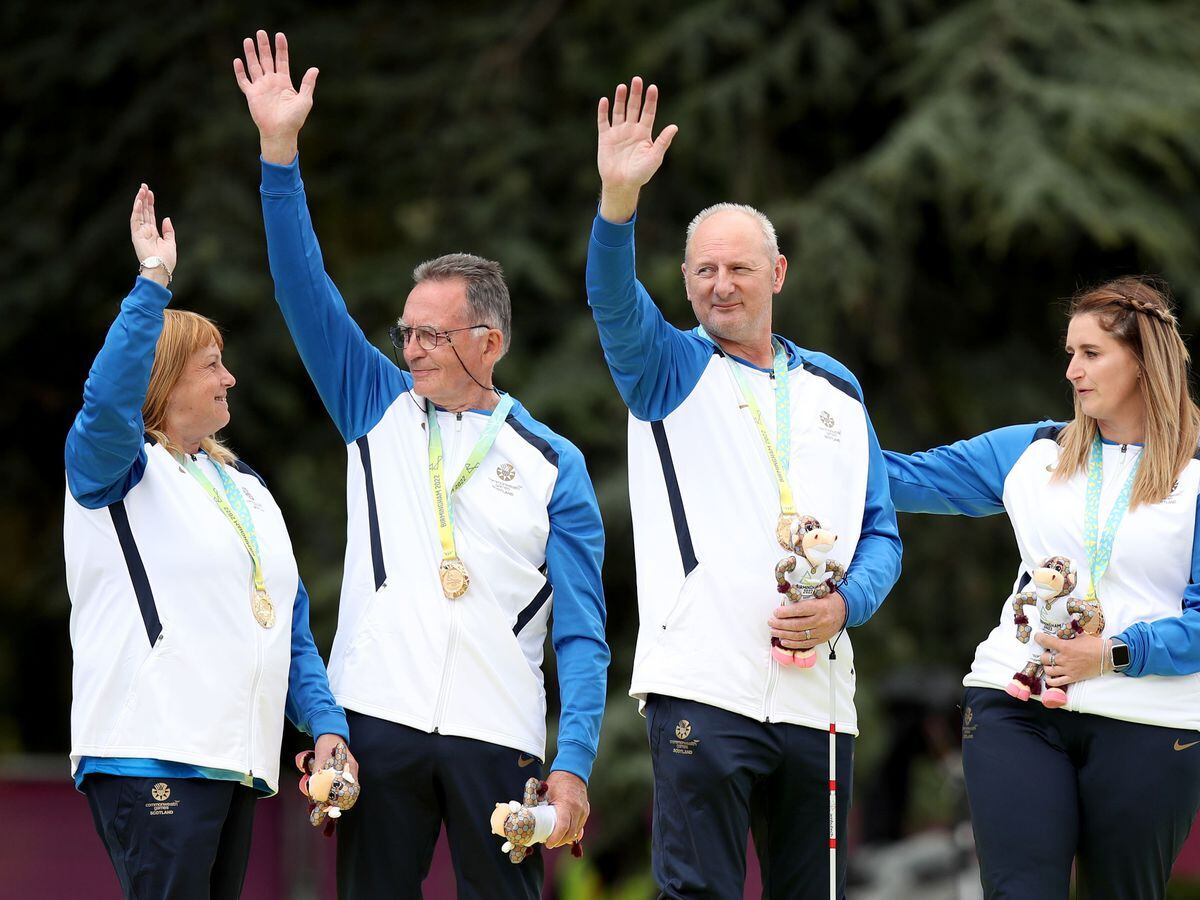 George Miller (second left) celebrates his historic Commonwealth Games gold medal