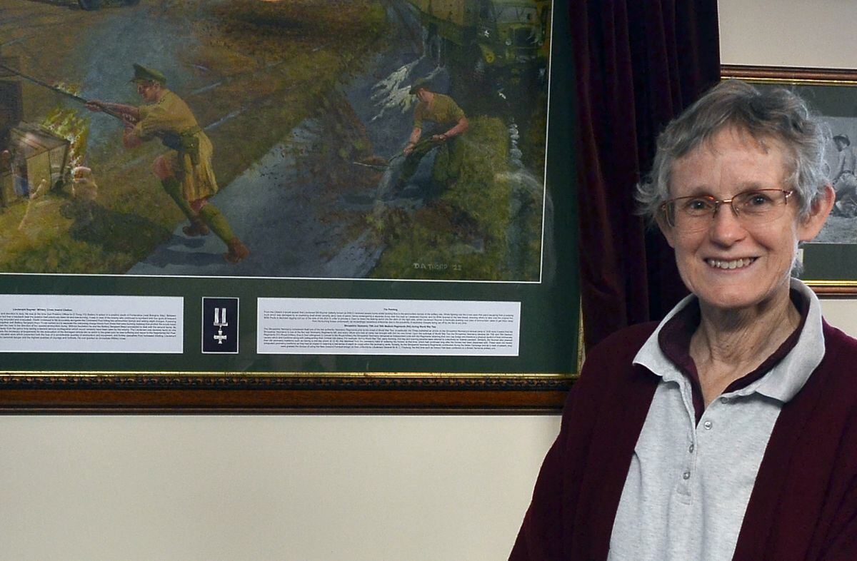 Dr Alison Morgan with the picture depicting her father's heroism.