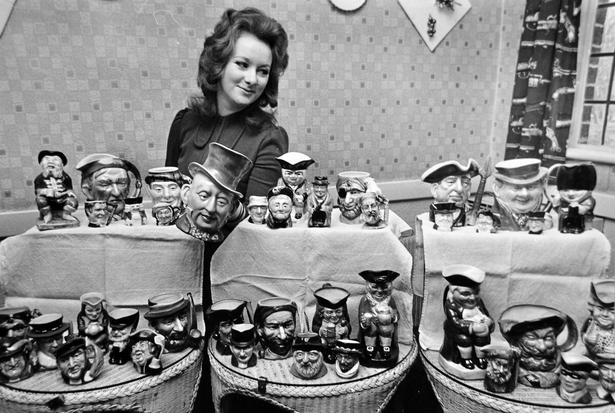 This collection of 60 Toby jugs and mugs was the result of nine years of collecting by licensee  Stan Lewis and his wife Alma of the White Lion, Moreton, near Oswestry. Admiring them is their 21-year-old daughter Hilary, who was a teacher in London. There is a Moreton and a Morton near Oswestry, but this is the Moreton with an "e" according to our photographer John Tibbott's original caption.