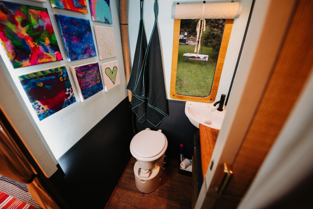 The bathroom features a compost toilet 