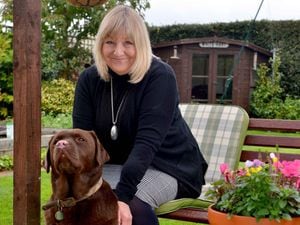 Councillor Ann Hartley in her garden with Mocha her chocolate labrador