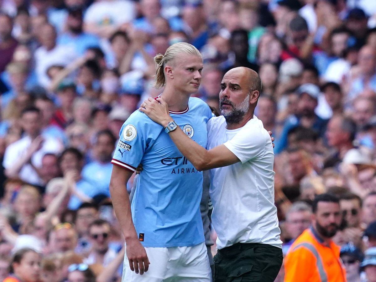 Manchester City manager Pep Guardiola greets Erling Haaland