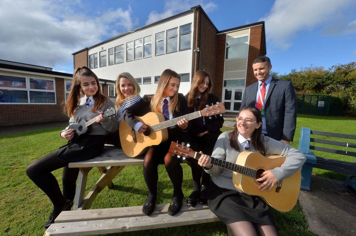 Having a Jam session in front of the Art and Music block are staff: Teacher: Alex Miller and Operations Manager: Nick Parkin, and pupils: Daisy Poole 14, Cairlin Jervis 14, Molly Ewings 14, Jessica Murless 14