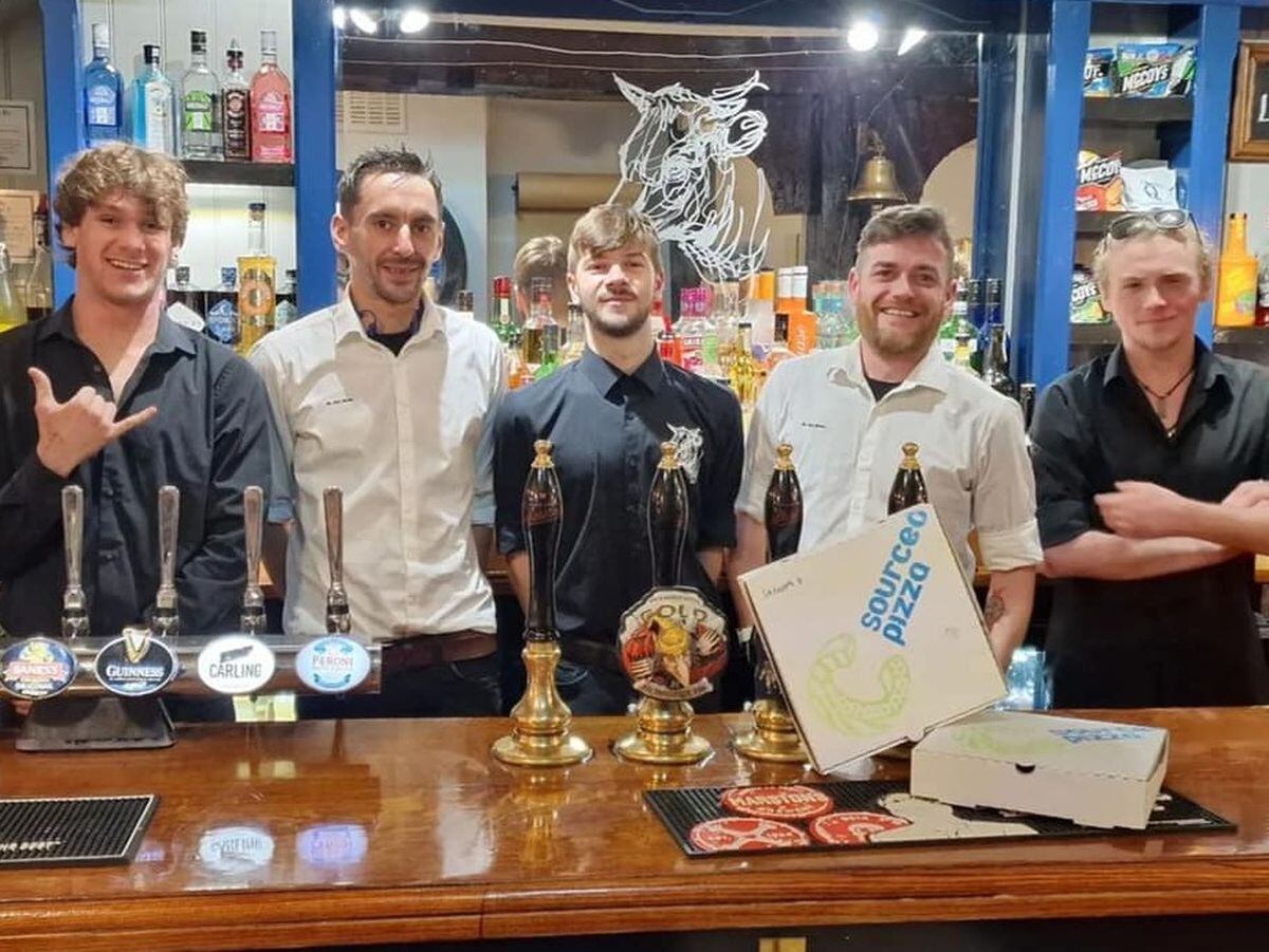 Robert Filbrandt (second right) and William Hutchinson (second left) with members of the Bull Hotel team