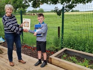 Angie Hotchkiss presenting Samuel Portas from Tilstock CE Primary School with his award