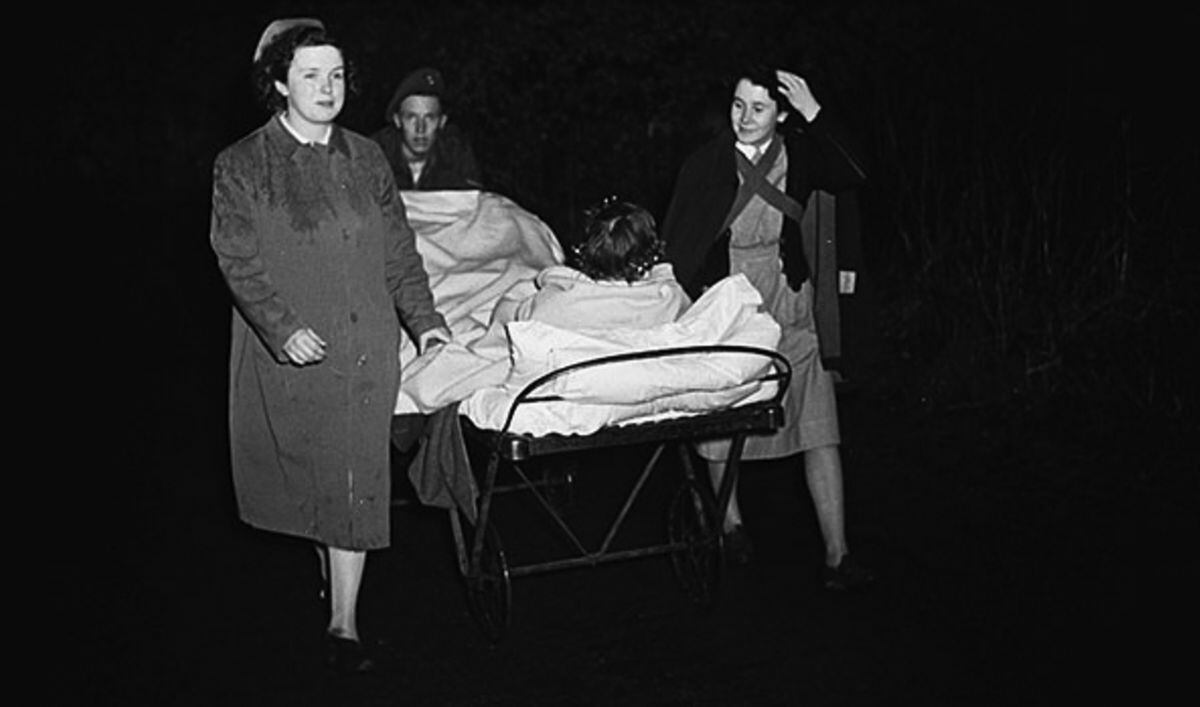 A patient is wheeled to safety