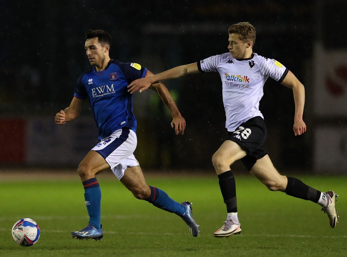 Carlisle United's Daniel Devine (left) and Salford City's Alex Denny battle for the ball during the Sky Bet League Two match at the Brunton Park, Carlisle..