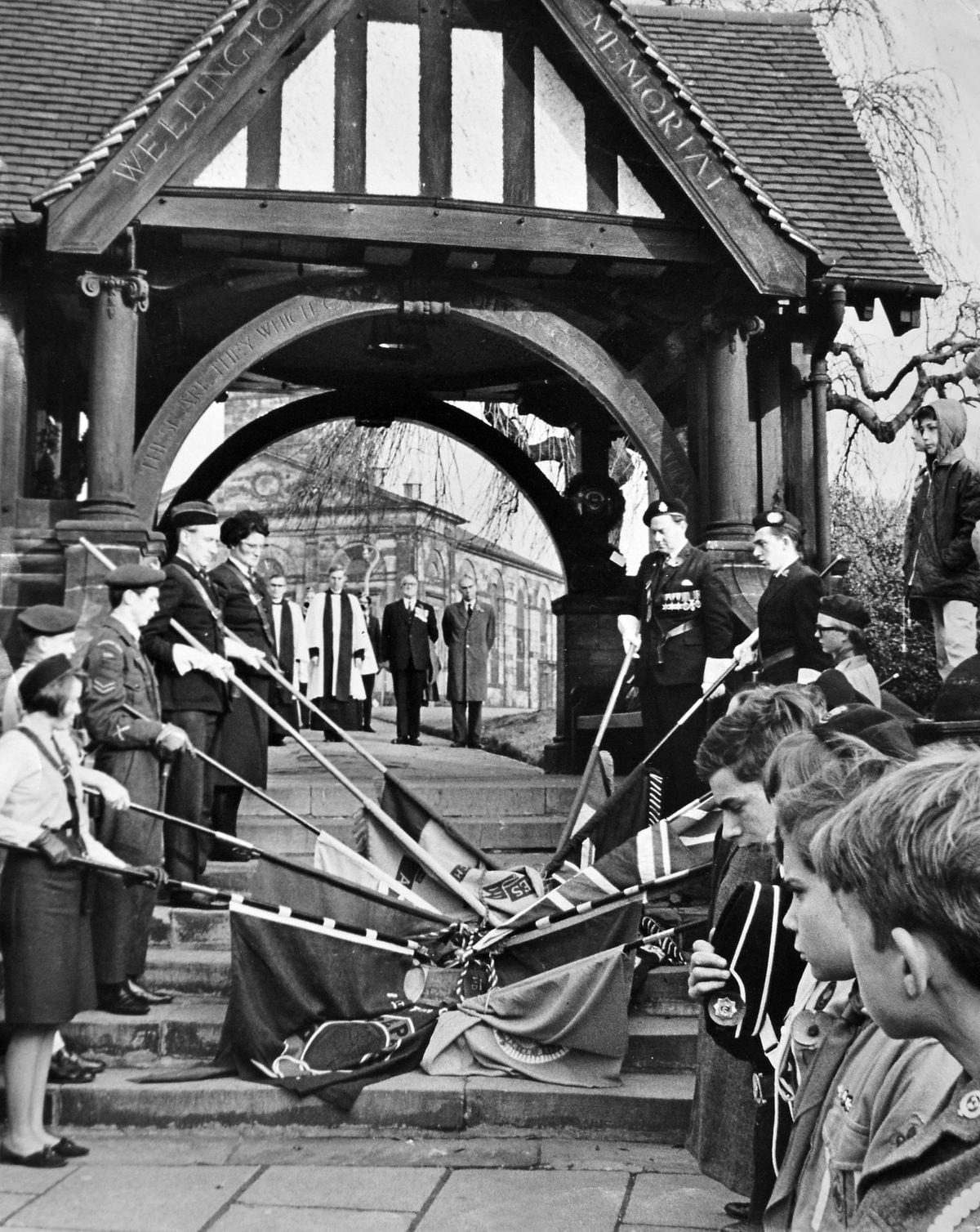 Remembering them... This is Wellington Remembrance Sunday with the standard bearers by the lych gate war memorial at All Saints Church. Our print has no information on when it was taken, but it is perhaps the mid to late 1960s.