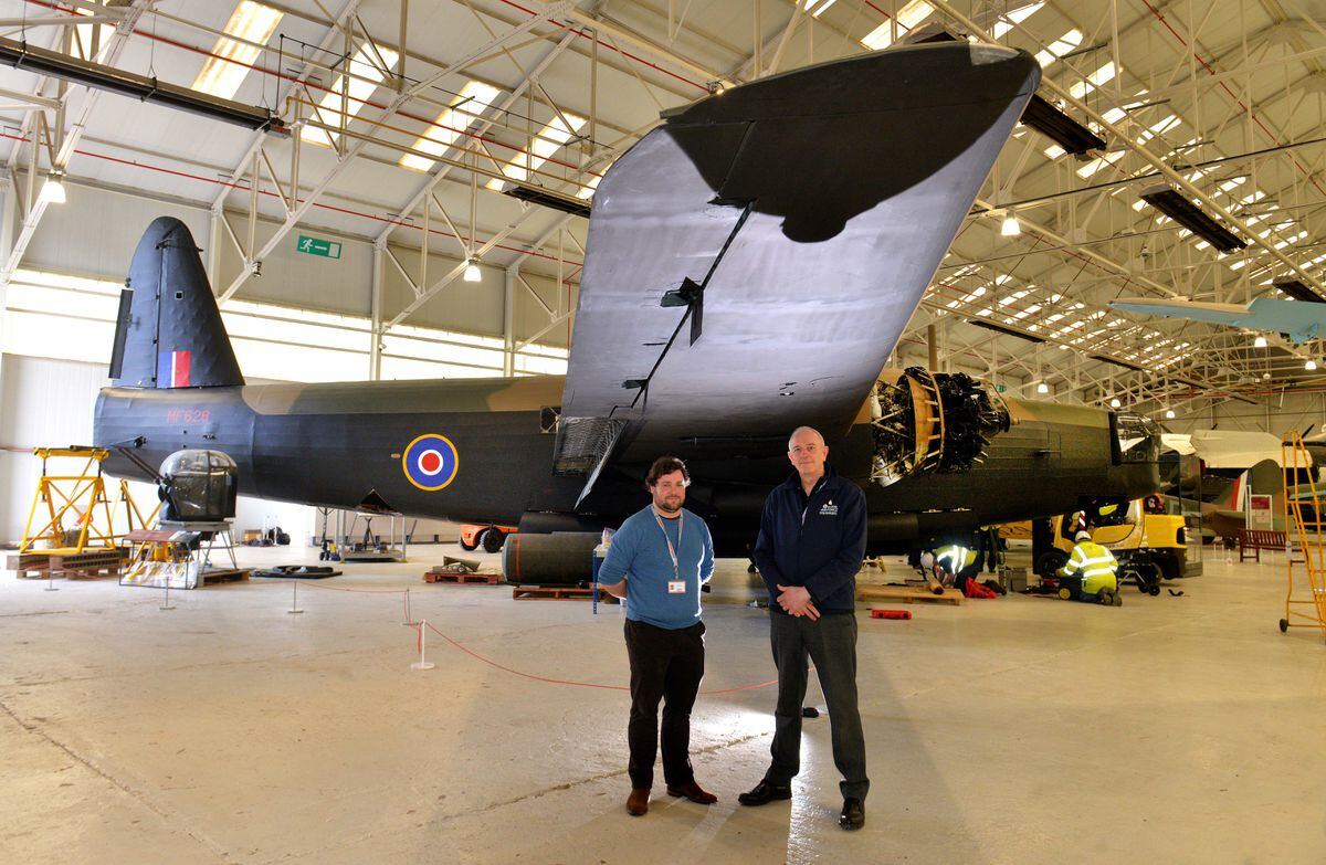Curator Tom Hopkins (left), conservation centre manager Darren Priday and the Wellington bomber