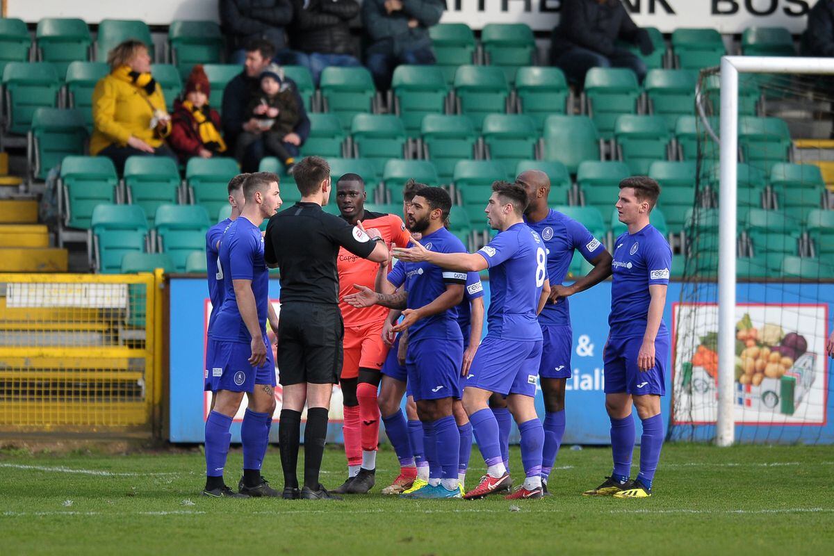 Telford players protest after referee Callum Walchester awards a controversial penalty to Boston 