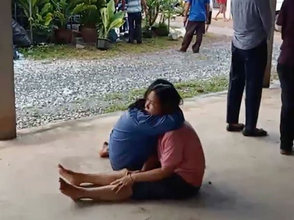 A distraught woman is comforted after the childcare centre attack