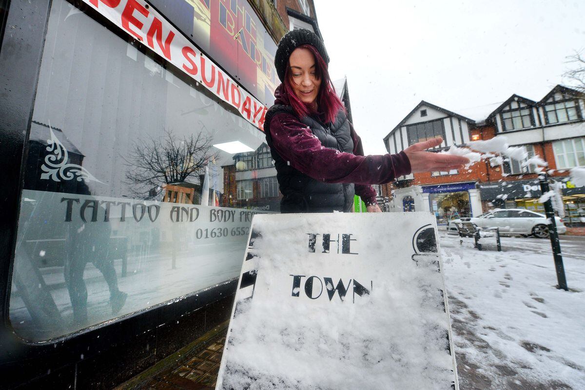 Rebecca Sutton clears her sign at The Town Barbers in Market Drayton