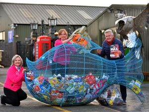 Chairman of the British Ironwork Centre, Clive Knowles, with staff Catrin Powell and Kerry Owen. The giant fish are being used to collect crisp packets, which will be recycled into survival blankets.