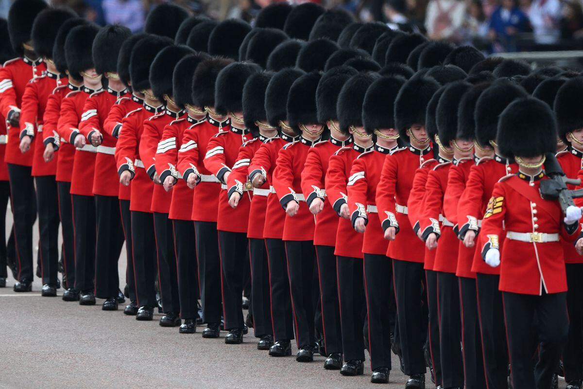 Members of the Household Division Foot Guards march along the Mall during the Trooping the Colour ceremony