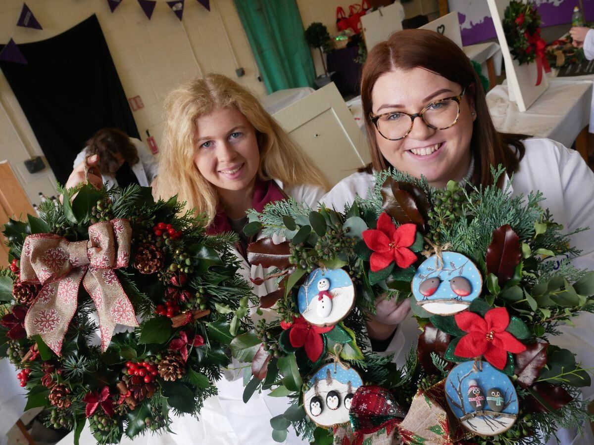 Lauren Kinsey-Owen of Aberedw Young Farmers Club and Sian Healey of Pontfaen Young Farmers Club with the Christmas wreaths they made in the YFC competitions. 