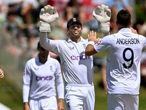 England's James Anderson, right, celebrates with teammate Ben Foakes