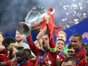 Liverpool captain Jordan Henderson lifts the Champions League trophy in 2019