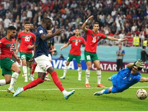 France's Randal Kolo Muani, centre, scores against Morocco