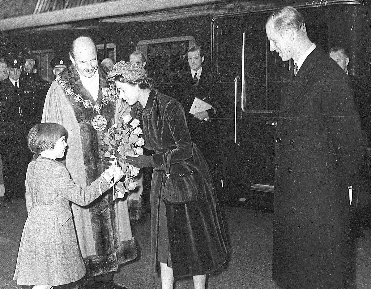 The Queen is greeted by Mayor of Shrewsbury Col J M West and his daughter Diana at Shrewsbury railway station