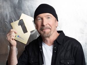 U2’s The Edge poses with his Official Number 1 Album Award for Songs Of Surrender from the Official Charts Company