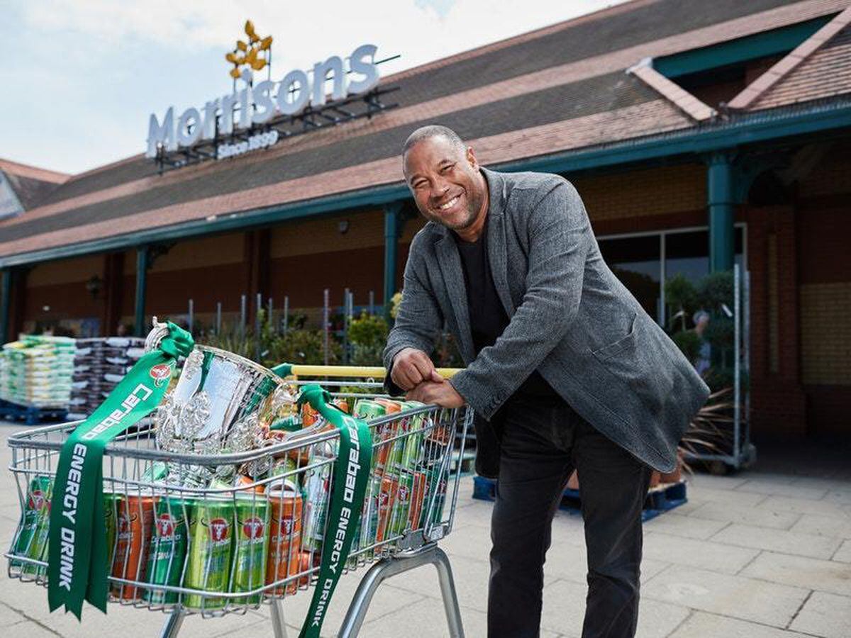 John Barnes poses with a trolley full of Carabao and the Carabao Cup