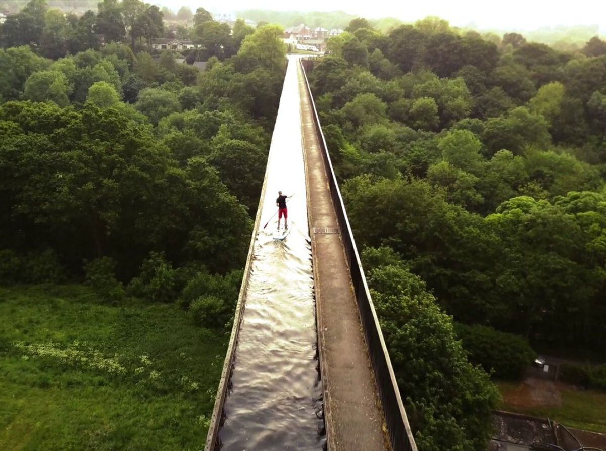 A paddle boarder on the Pontcysyllte Canal aqueduct over the River Dee