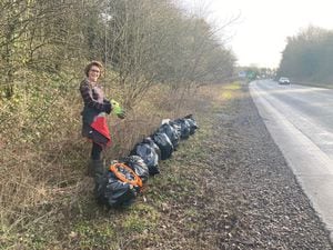 Ludlow Womble Imogen Jones with a line up of rubbish collected from the side of the A49. Photo: Sam Jones