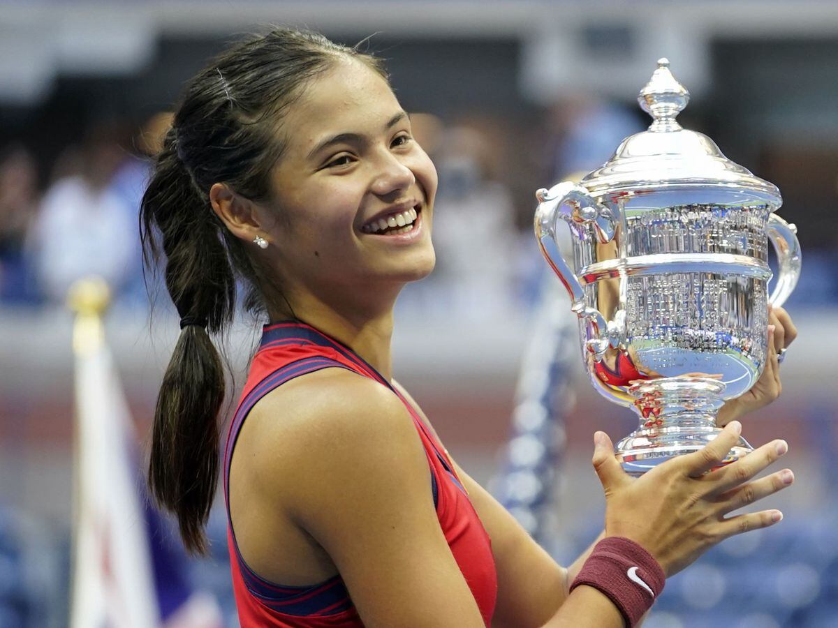 File photo dated 11-09-2021 of Great Britainâs Emma Raducanu holds the trophy as she celebrates winning the womenâs singles final on day twelve of the US Open at the USTA Billie Jean King National Tennis Center, Flushing Meadows in 2021