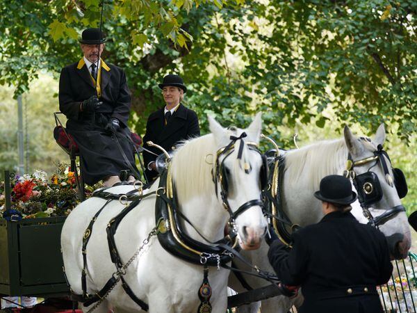 Royal Parks staff and volunteers remove floral tributes from Green Park in London