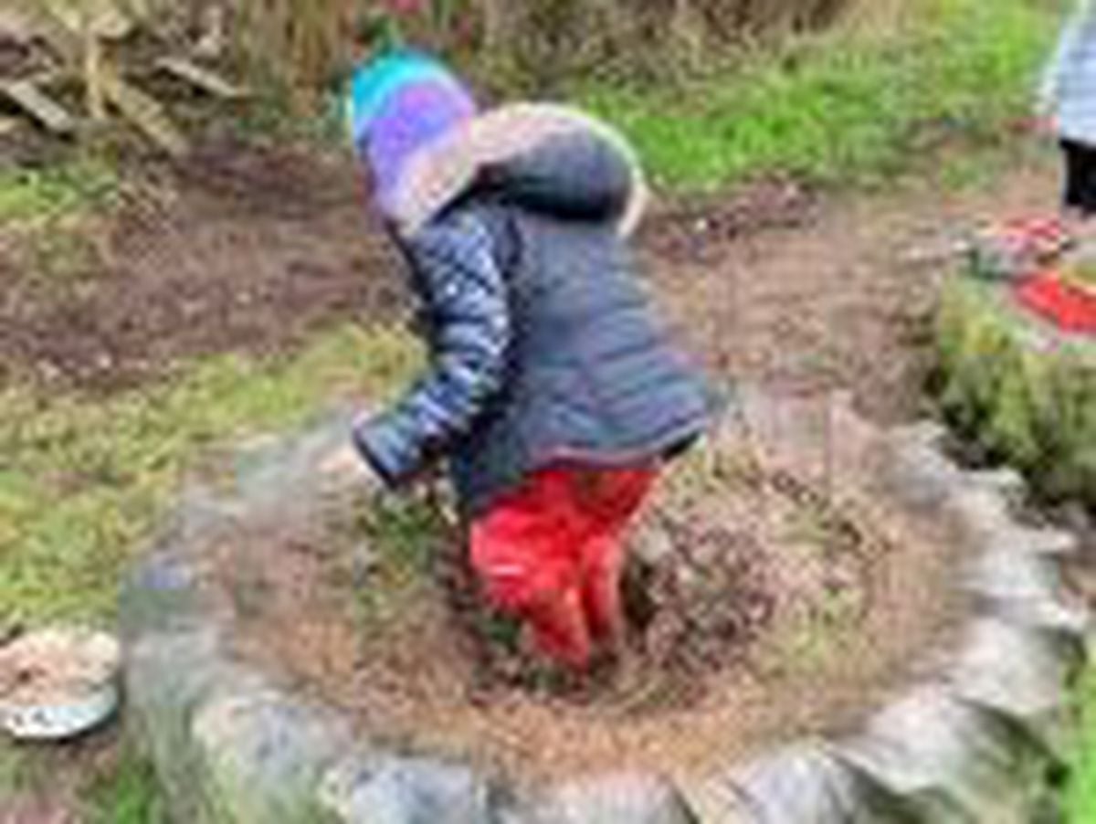 A pupil enjoys some fun in the outdoor learning space at Tilstock Primary School
