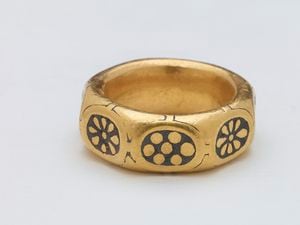 A unique gold octagonal finger ring dated to the 9th century with black niello rosette and flower motifs on each of its eight facets. It is decorated in the Anglo-Saxon Trewhiddle style.