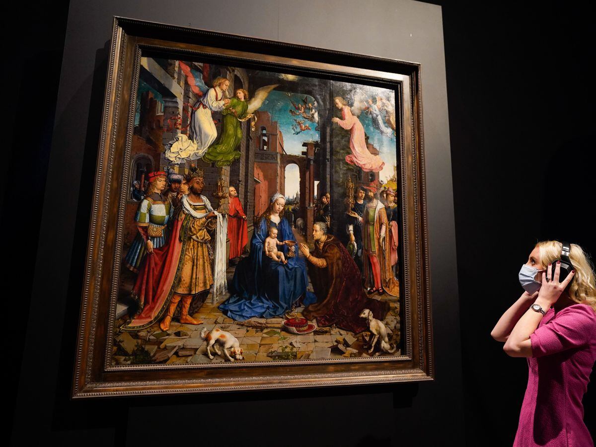A person looks up at a copy of Jan Gossaert’s Adoration Of The Kings (Andrew Matthews/PA)