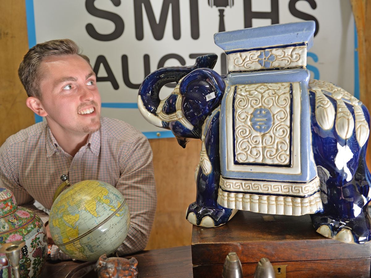 Mitchell from Smiths Auctions pictured with a ceramic elephant  