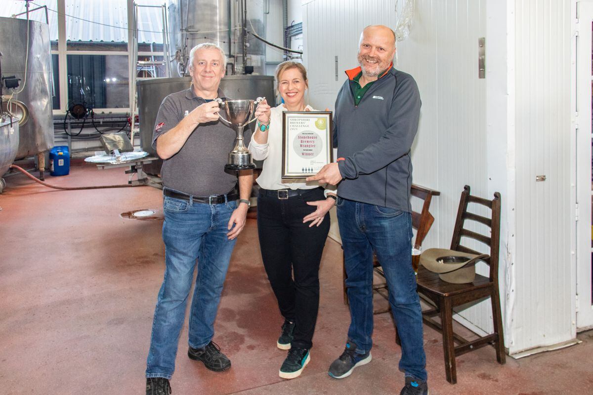 Dave Ricketts presenting the cup to Alison Parr and the certificate to Shane Parr, owners of Stonehouse Brewery