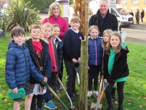 Councillor Kate Halliday and Belle Vue and Coleham Community Action Group's John Ingham with Coleham Primary School pupils planting the tree