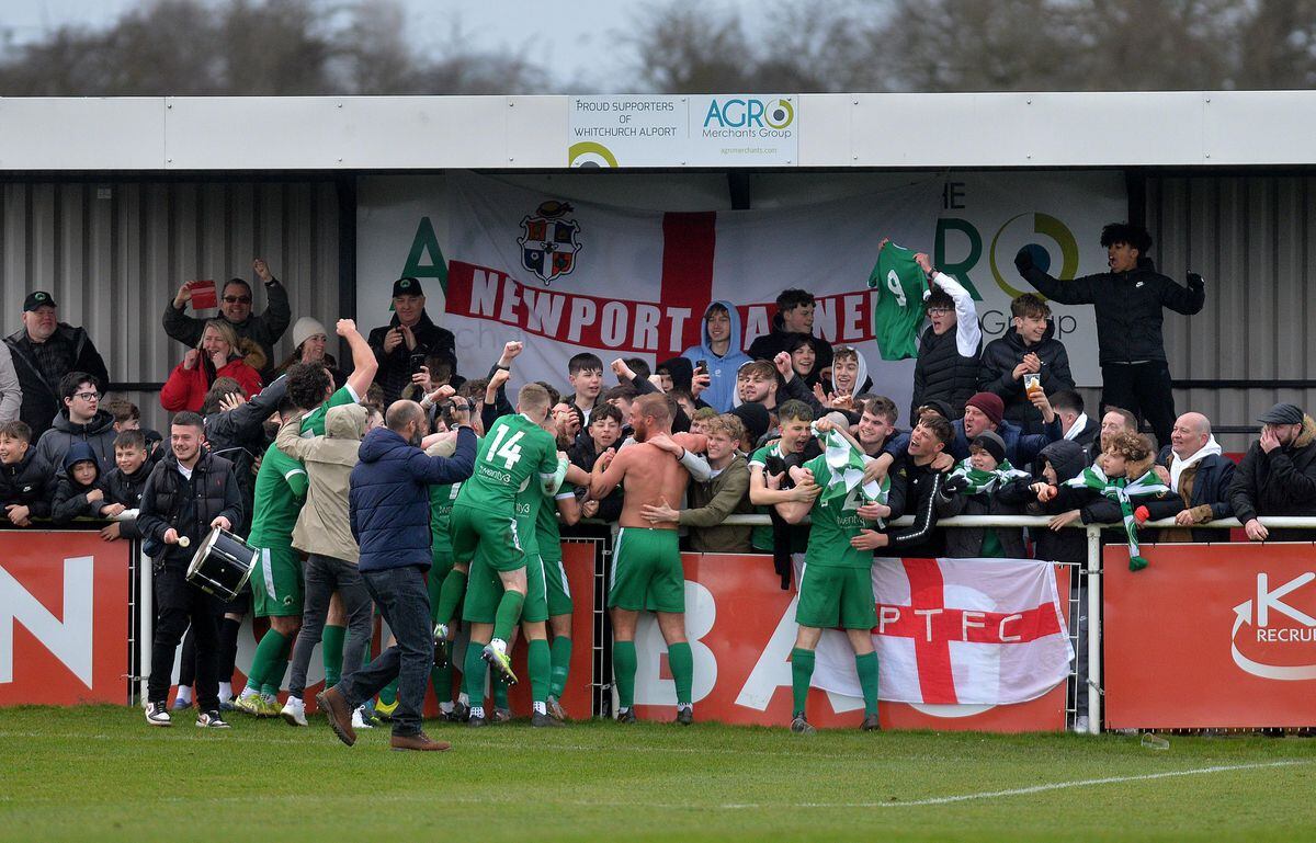 The Newport Pagnell fans celebrate the win