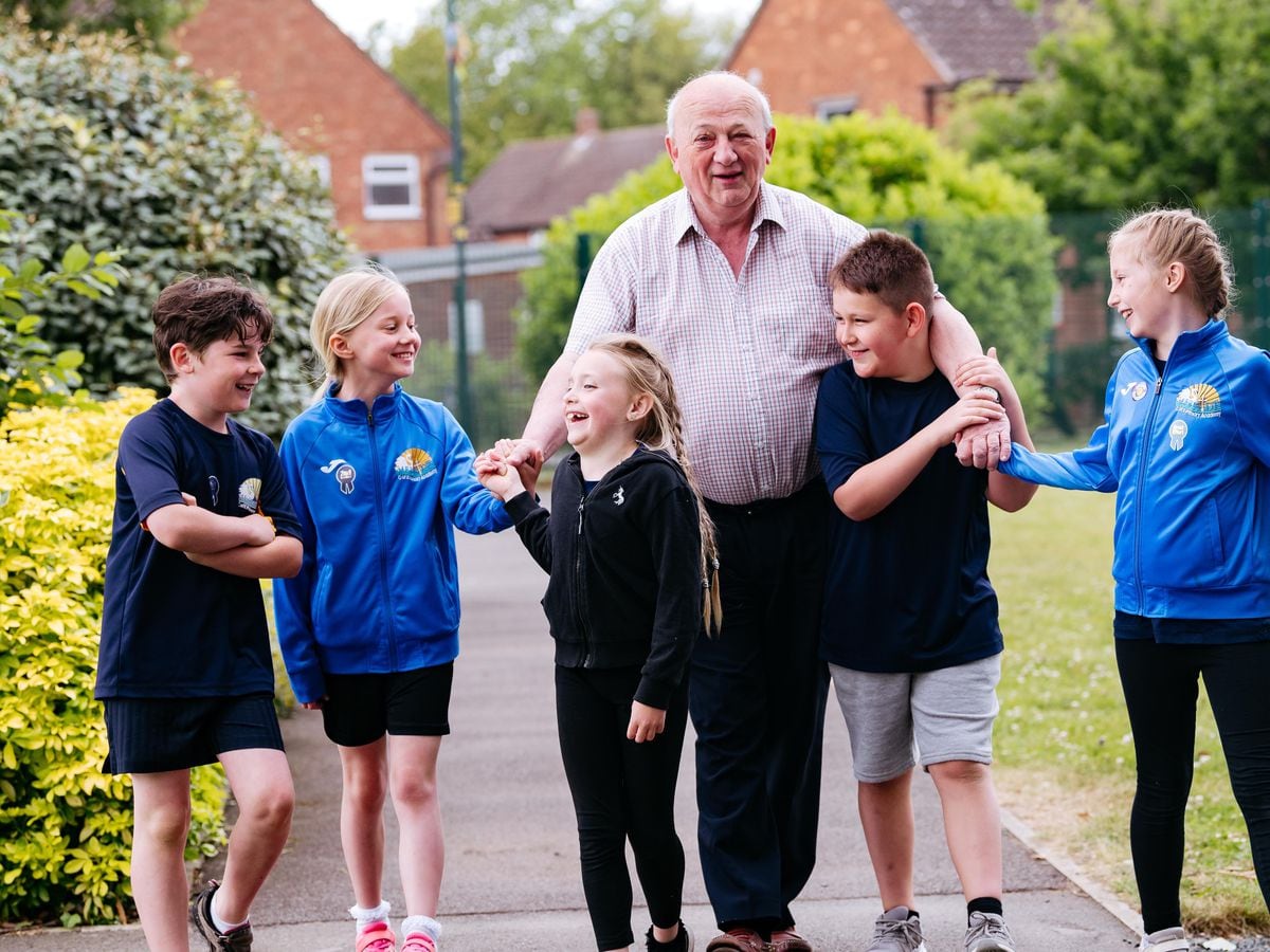 Long-time dinner man Terry Beeston, aged 74, says goodbye to the school with some of the current pupils