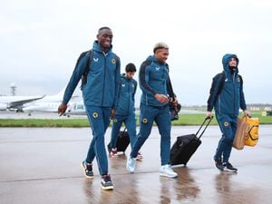 Toti Gomes, Adama Traore and Daniel Podence are all smiles as they head to the plane in the rain (Photo by Isaac Parkin - WWFC/Wolves via Getty Images)