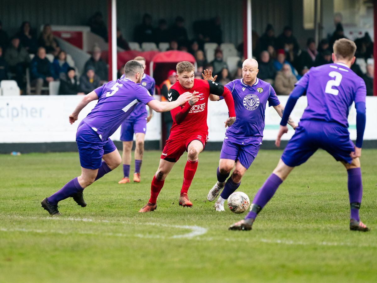 NORTH COPYRIGHT SHROPSHIRE STAR JAMIE RICKETTS 15/01/2022 - Whitchurch Alport F.C (red) vs Congleton Town (Purple) in the forth round of the FA Vase at Whitchurch. In Picture: 10 Jimmy Garlick on the ball (Whitchurch).