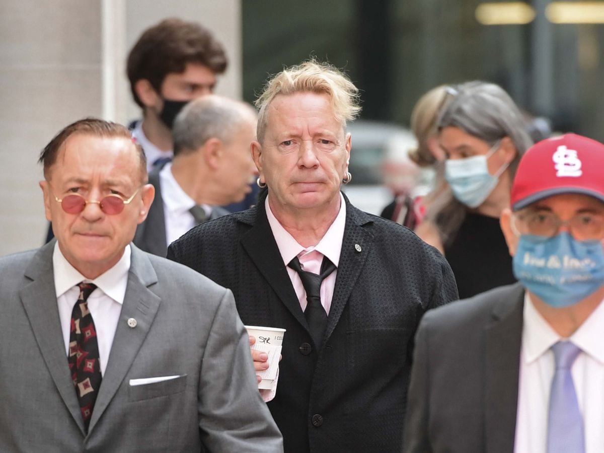John Lydon, aka Johnny Rotten, centre, arrives at court