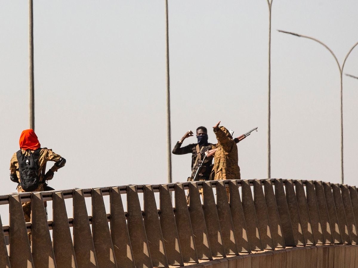 Mutinous soldier stand on a bridge at the Bobo interchange near the Lamizana camp in Burkina Faso’s capital Ouagadougou (Sophie Garcia/AP)