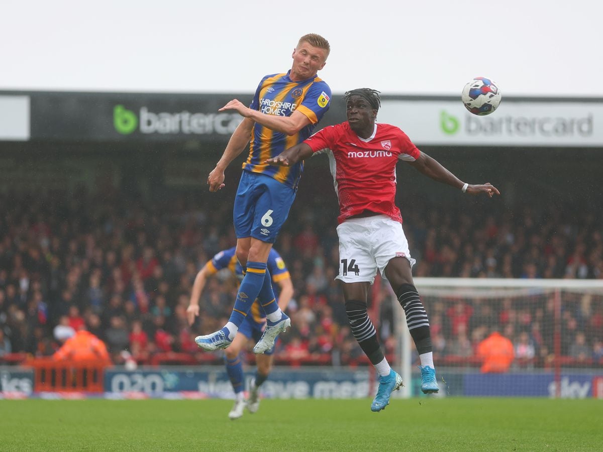 Taylor Moore of Shrewsbury Town and Arthur Gnahoua of Morecambe.