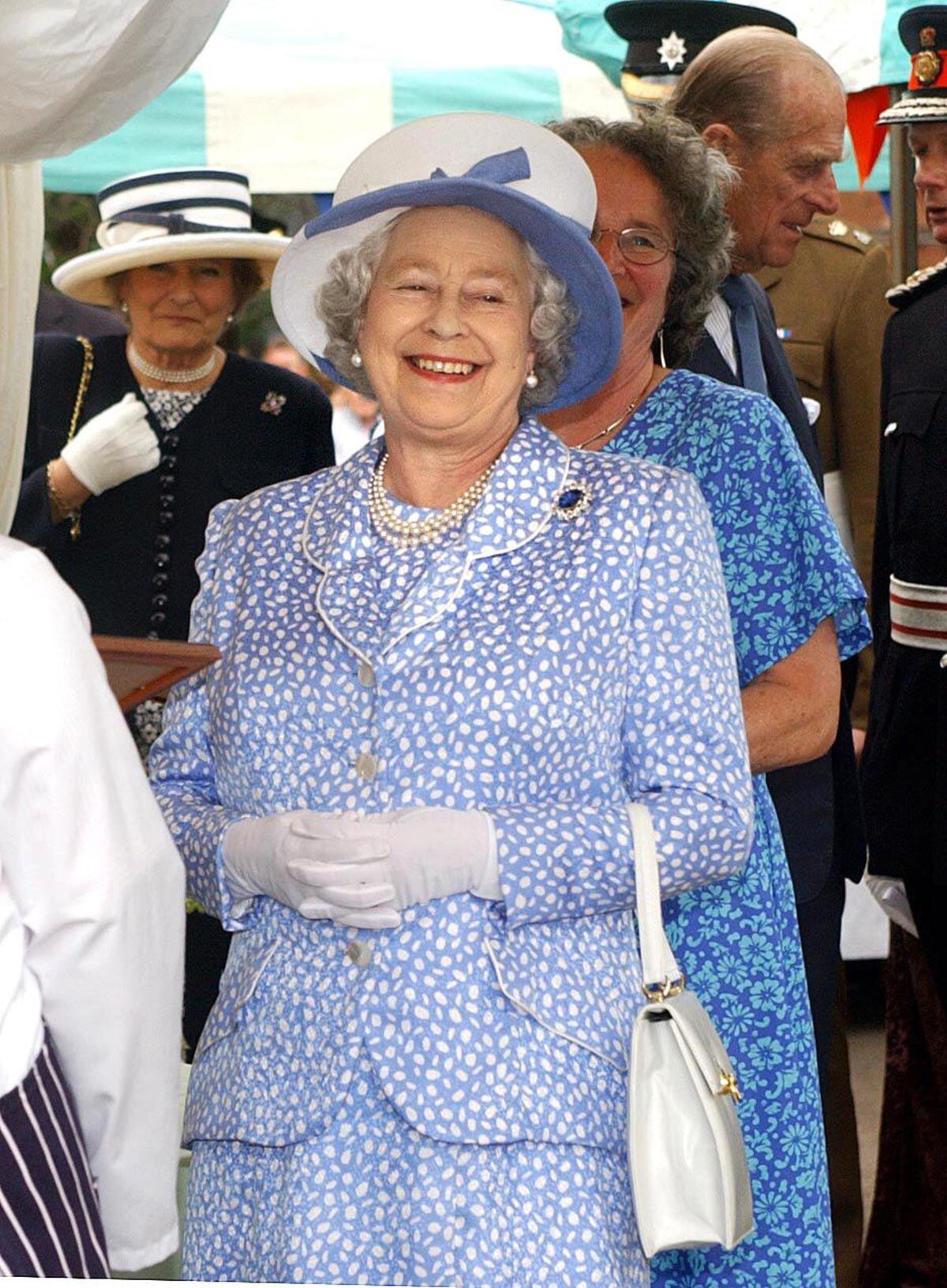 Queen Elizabeth II enjoying a joke during a visit to Ludlow Market