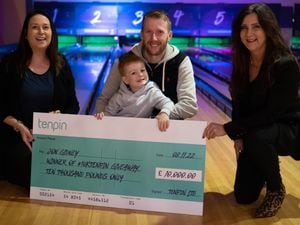Jon and his son, three-year-old Ralph, receiving the cheque from Tenpin employees