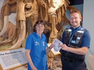 Stephanie Bellows, learning manager at the Shropshire Hills Discovery Centre, receiving £200 from PCSO Darren Barnet of South Shropshire SNT