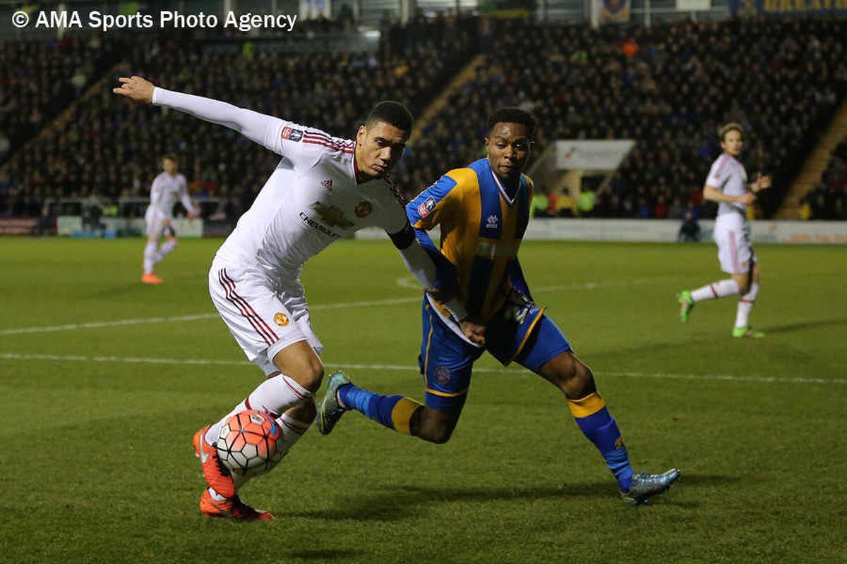 Chris Smalling of Manchester United and John-Louis Akpa Akpro of Shrewsbury Town