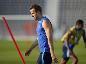 England's Harry Kane, left, takes part in drills during a training session at Al Wakrah Sports Complex on the eve of the group B World Cup soccer match between England and Wales, in Al Wakarah, Qatar, Monday, Nov. 28, 2022. (AP Photo/Abbie Parr).