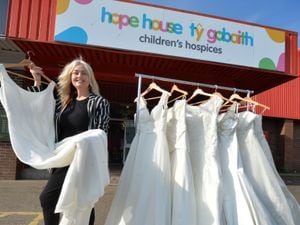Hope House area manager Fiona MacDougall, at the charity's shop in Shrewsbury showing off some of the wedding dresses for sale.