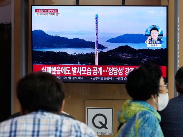 A TV screen shows an image of North Korea’s rocket launch